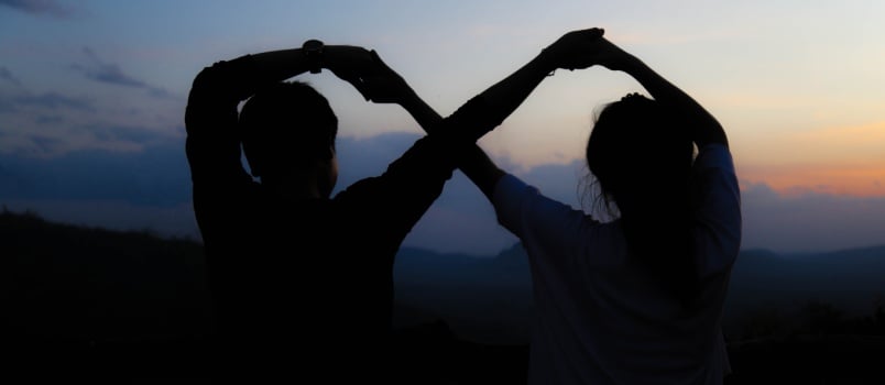 Couple making infinity sign with hand