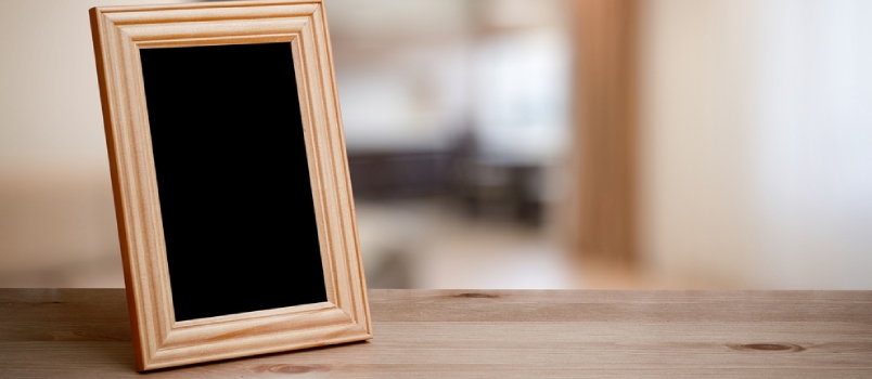 Photo Frame On The Wooden Table In The Living Room