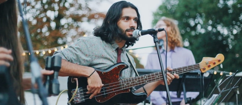 Man Playing Guitar on Stage in The Wedding Party