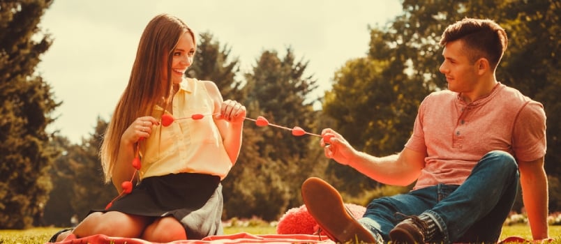 Enamoured Couple In Park. Girl And Boy In Park On Picnic, Love Romance Concept