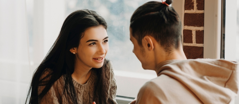 Young Happy Couple Talking In A Cafe