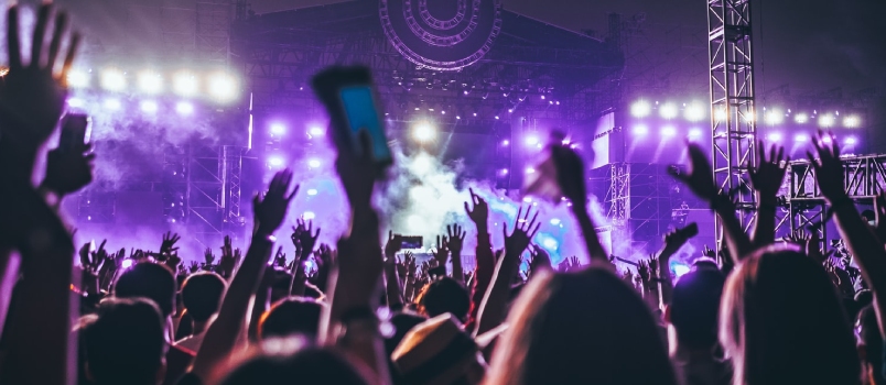 Group Of People Raising There Hands In Concert