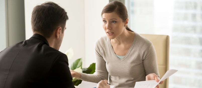Angry Businesswoman Arguing With Businessman About Paperwork Failure At Workplace