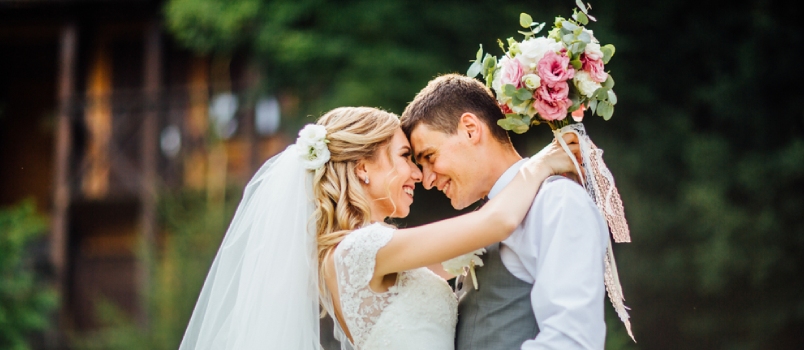 Newlyweds Couple In Love Looks One-on-one With Flowers