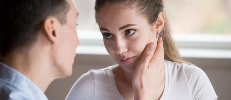 Women Looking At Man Emotionally And Man Point Hand On Her Face In Love