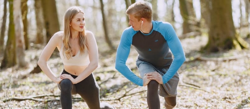 Photo of Couple Exercising While Looking at Each Other