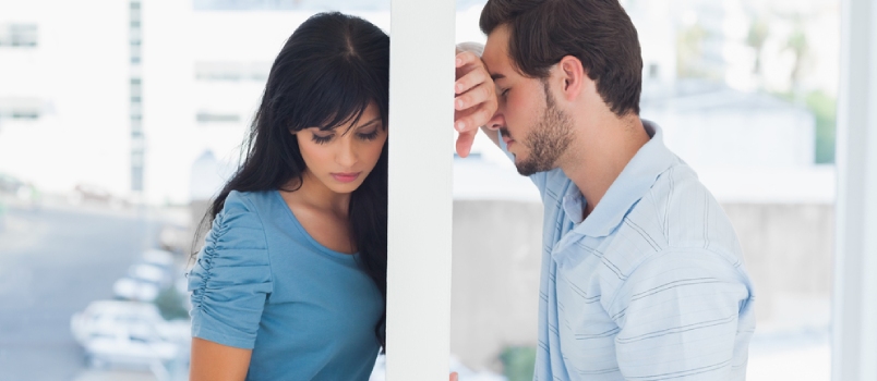 Divided Couple Are Separated By White Wall But Holding Hands