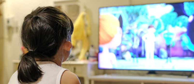 Asian Child Girl Watching A Television. Cartoon Time