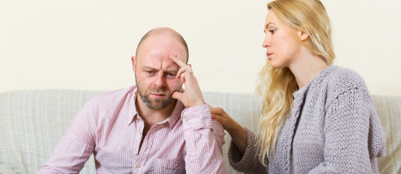 Sad Man Has Problem, Woman Consoling Him On Sofa At Home