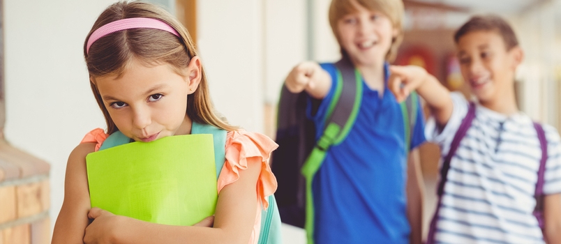 School Friends Bullying A Sad Girl In Corridor At School