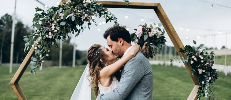 Soulful Photo Of The Newlyweds Hugging And Kissing Each Other During The Wedding Ceremony