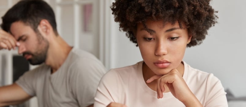 Young Wife And Husband Have Problems In Family Life, Stressed Bearded Man Sits In Background