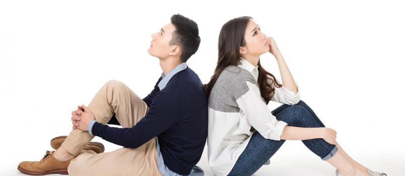 Two Young Couple Sitting Back To Back And Thinking Something