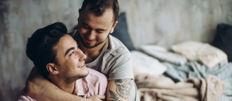 Gay Couple Looking At Each Other And Smiling In Love