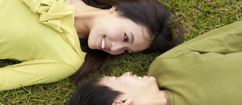 Beautiful Girl And Man Lying On The Grass In The Park Love Dating Concept