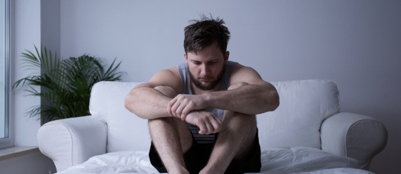 Sad Man Sitting On Couch With Folding There Hand Feeling Lonely