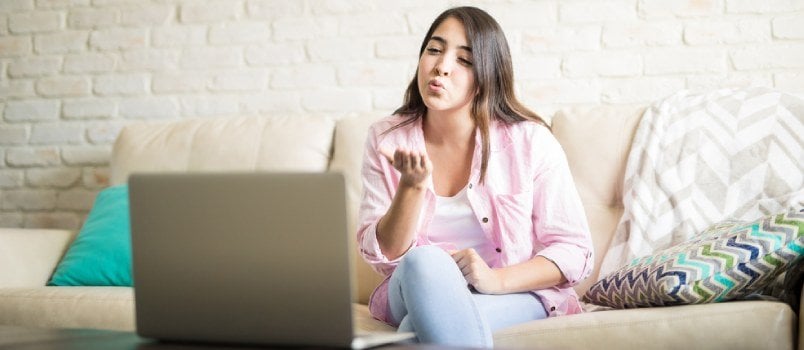 Women Giving Flying Kisses On A Laptop While Video Chatting