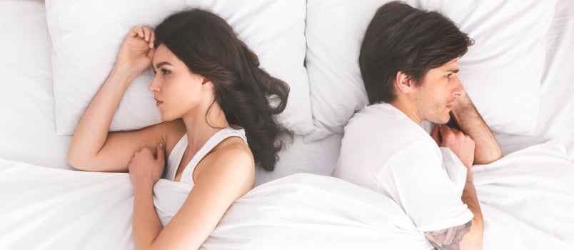 Relationship Problems. Upset Couple Ignoring Each Other, Lying Back To Back In Bed, Top View