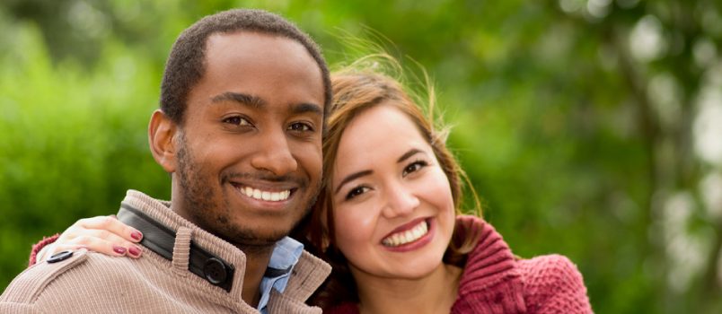 American Lady And African Men In The Park With Wearing Winter Dress Smiling Happily In Love Concept