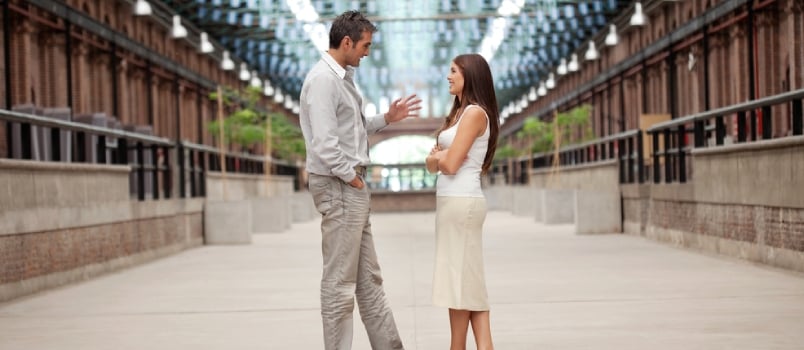 Full Length Of Handsome Man Talking To Beautiful Woman