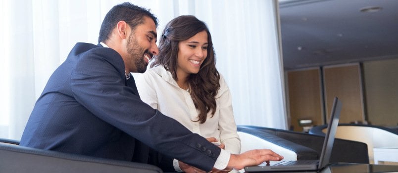 Businessmen And Women Are Discussing Something On A Laptop In The Office