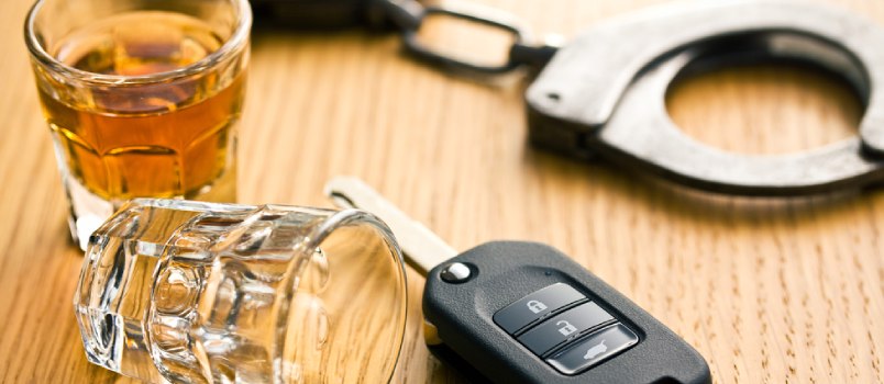 Beer With Glass With Car Key And Handcuffs On The Table