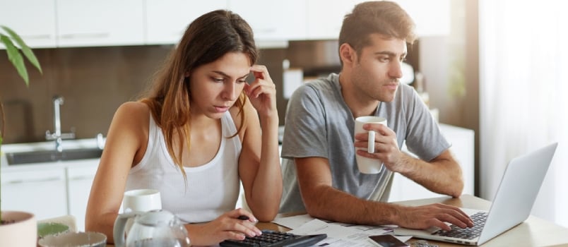 Young Couple In Love, Preparing For Their Wedding, Calculating All Expenses, Booking Cafe Over Internet Using Laptop Computer