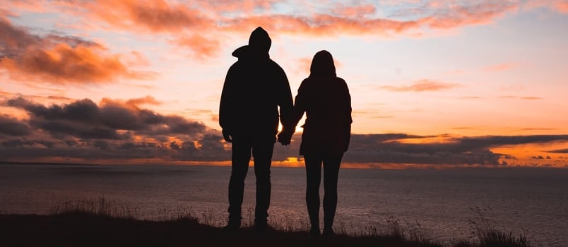 Silhouette Photo Of Man And Woman On Cliff Beautiful Sunset View