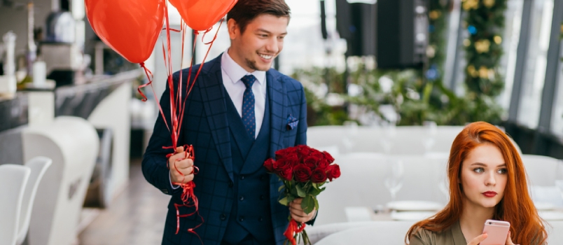 Attractive Redhaired Lady Wait For A Man Sweetheart In Executive Restaurant, Beautiful Woman Using Smartphone While Waiting