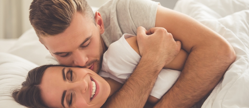 Happy Loving Couple Having Romance Together On Bed