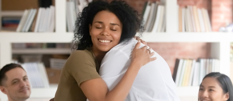 Relieved Smiling Black Woman Hug With Friend Showing Support And Empathy At Group Therapy Session