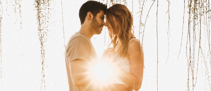 Man Wearing Beige Crew-neck Shirt And White Jeans Holding Hands With Woman Wearing Pink Dress Having Romance Together