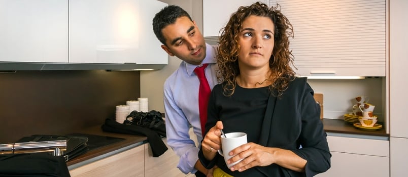 Businessman Embracing To Offended Woman At Home