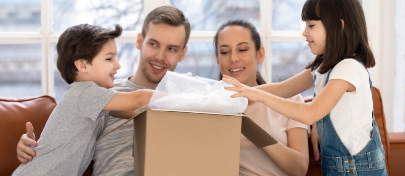 Excited Preschooler Boy And Girl Little Siblings Unpack Open Cardboard Box Package Shopping Online With Parents