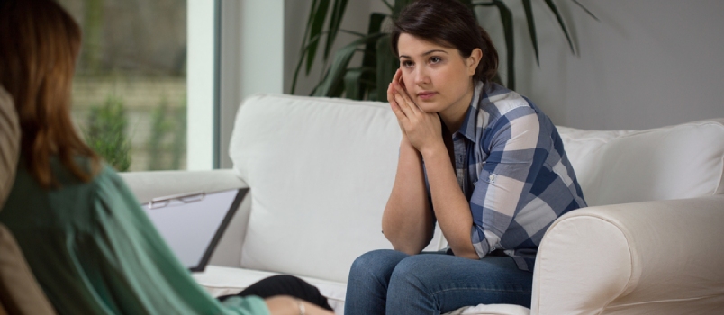 Young Woman Talking With Psychologist About Her Problems