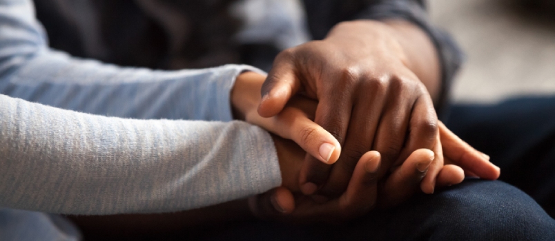 Close Up Black Woman And Man In Love Sitting On Couch Two People Holding Hands
