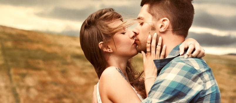 Stunning Sensual Outdoor Portrait Of Young Stylish Fashion Couple Kissing In Summer In Corn Field Behind Rainy Clouds And Storm