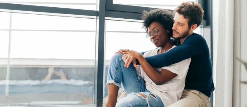 Romantic Mixed Race Affectionate Young Newlyweds Relax At Modern Hotel Interior While Vising Foreign Country In Vacation