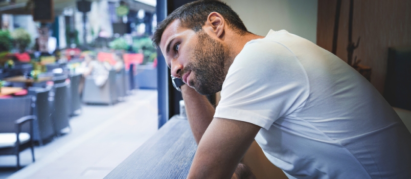 Man Thinking By The Bar Window