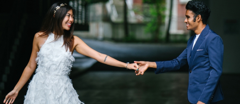 A Newly Engaged Interracial Couple Take Their Pre-wedding Photographs In The Day In A Park