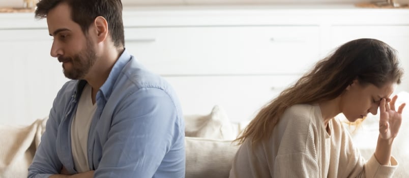 Sad Disappointed Millennial Couple Sit Separately On Couch Avoid Talking After Family Fight