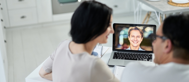Happy Marriage Counselor Smiling To His Clients, Using Video Chat App