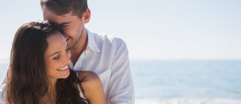 Attractive Couple Cuddling At The Beach