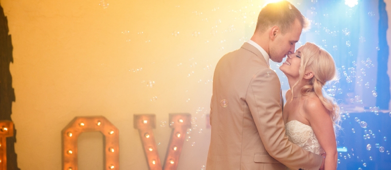 Newlywed Couple Dancing In Dance Hall At Wedding Party