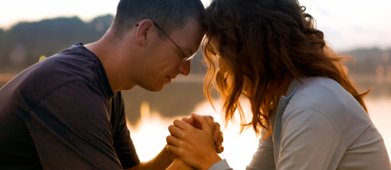 Couple Praying Together Holding Their Hands Together