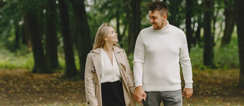 People Park Woman Brown Coat Man White Sweater Walking Together And Looking In Each Other Eyes