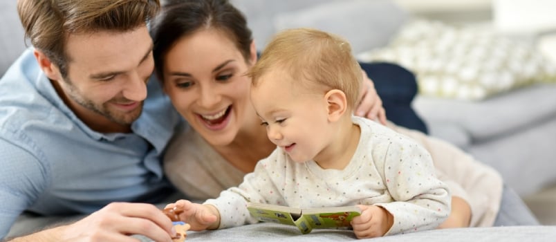 Happy Parents Enjoying Playing With Baby Girl