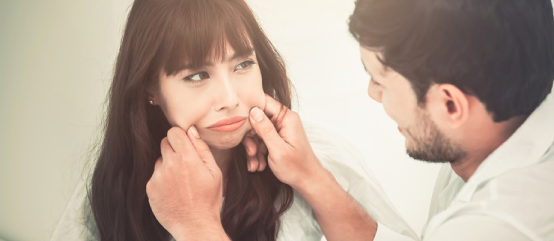 Couple In Love Is Touch The Cheeks And Tease Each Other On The Bed In The Bedroom