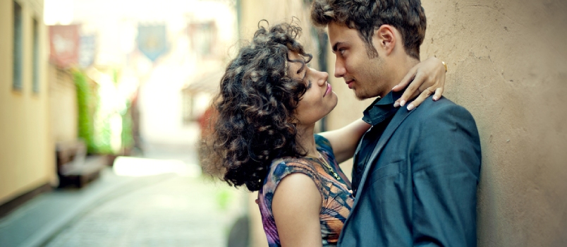 Young Couple Kissing in the Street of the Old City in Spain