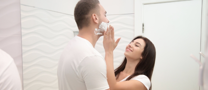 Young Playful Smiling Woman Playing While Applying Gently Shaving Foam For A Man To Shave